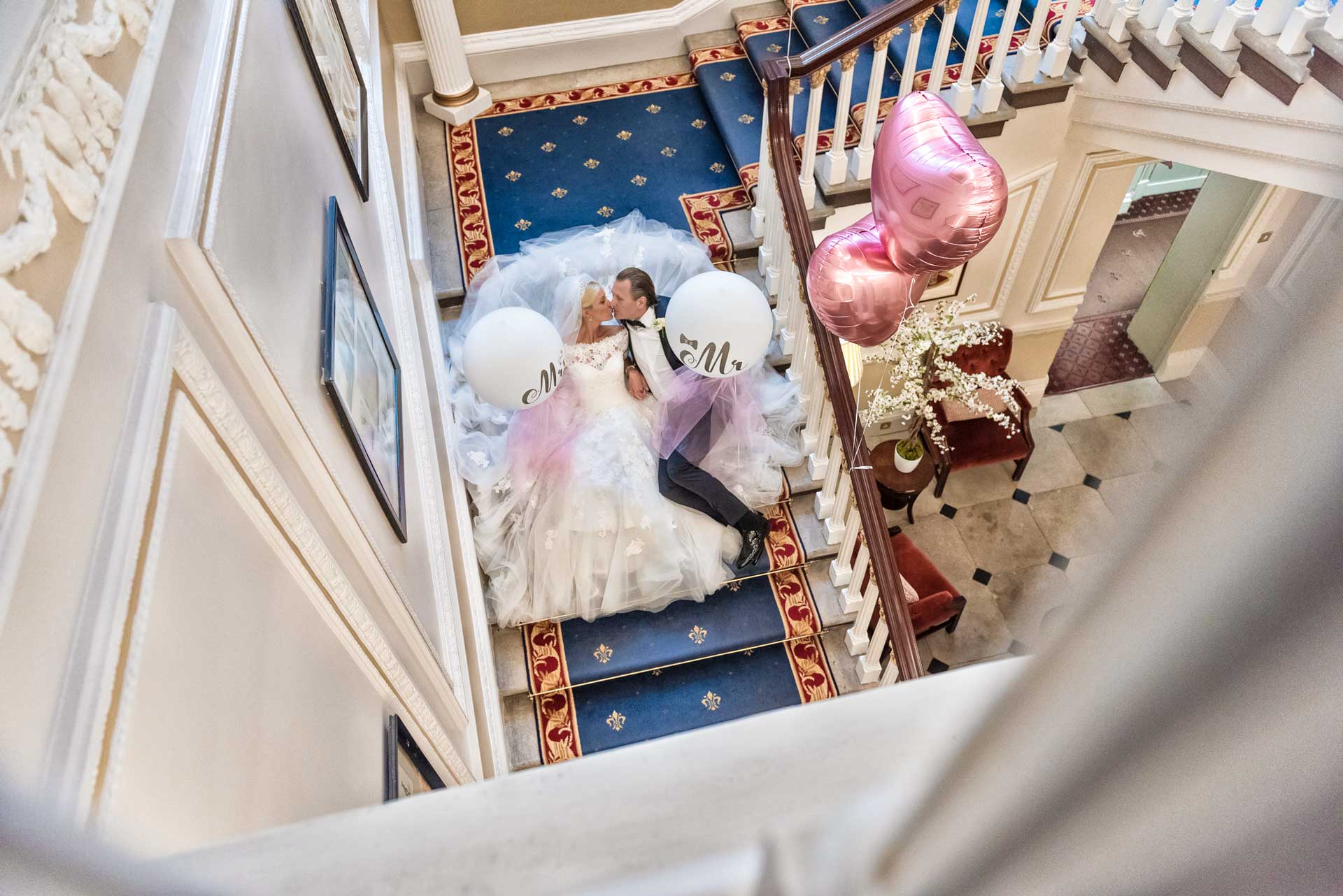 London, UK & Worldwide Wedding Photographer & Videographer | Candid & Authentic Wedding PHOTOGRAPHY & VIDEOGRAPHY. Groom & Bride kissing in the stairs of In & Out London Club. Packages & Pricing list.