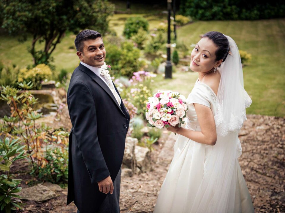 London, UK & Worldwide Wedding Photographer & Videographer | Candid & Authentic Wedding PHOTOGRAPHY & VIDEOGRAPHY. Groom & Bride walking in the garden of the venue