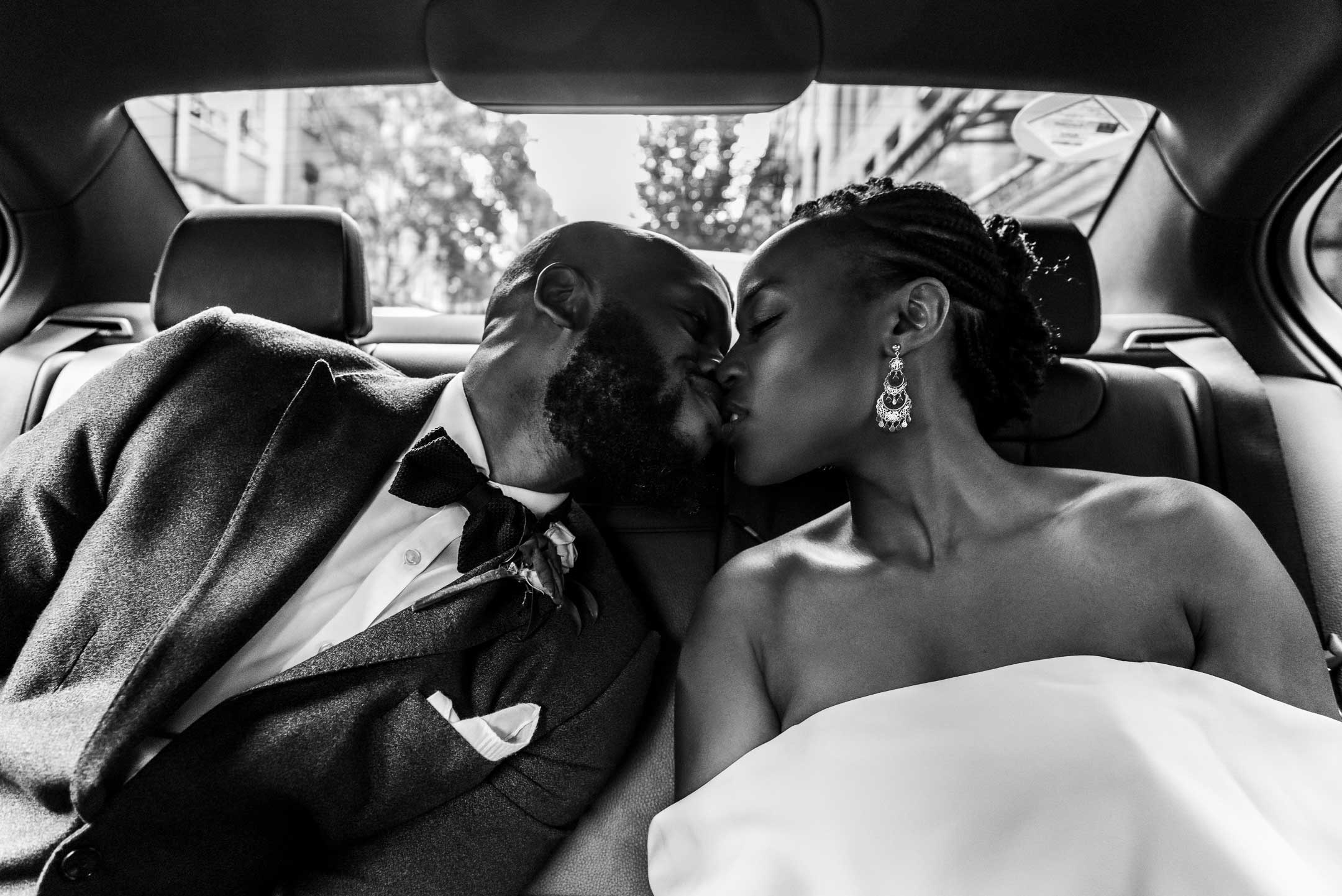 London, UK & Worldwide Wedding Photographer & Videographer | Candid & Authentic Wedding PHOTOGRAPHY & VIDEOGRAPHY. Groom & Bride kissing in the car.