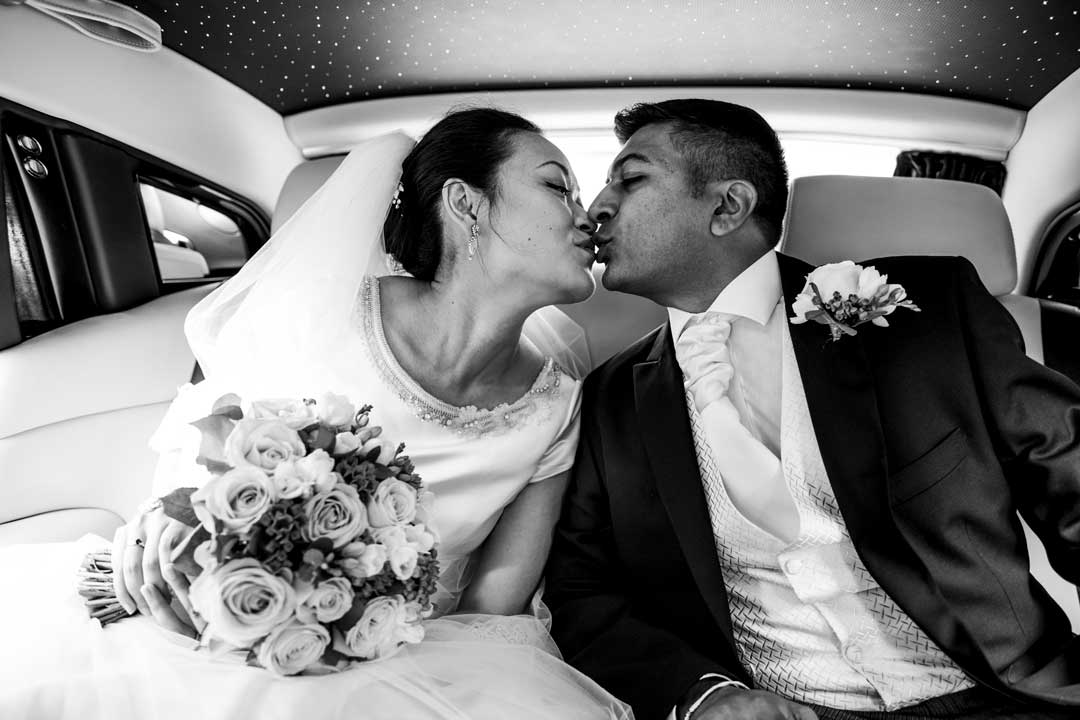 Packages & Pricing list. Photography & Videography. A bride & groom kissing in the wedding car